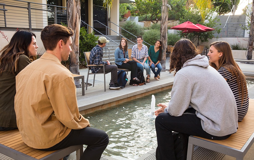 Students hang out by the Talbot East fountain.