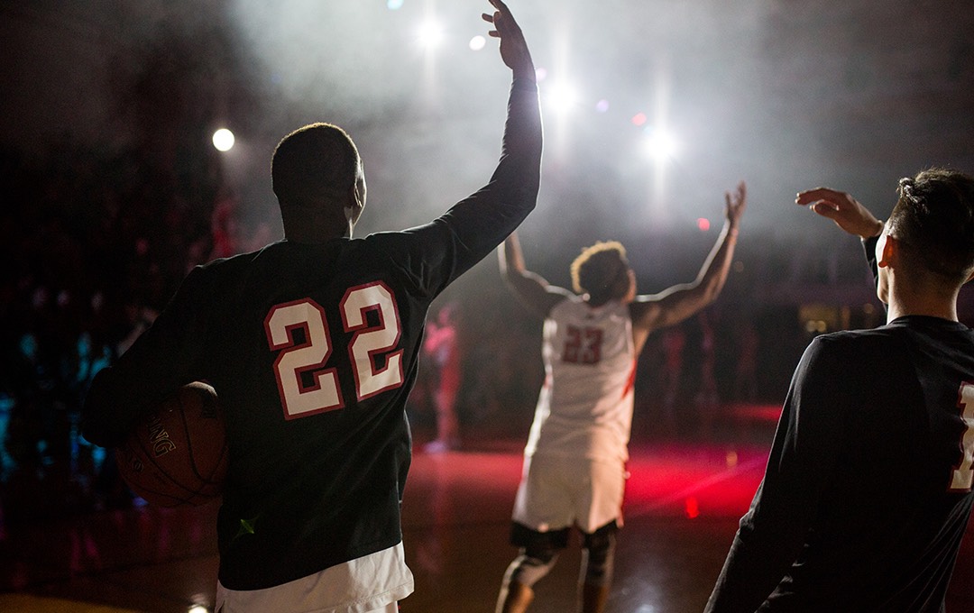 Basketball players enter the court during Midnight Madness.