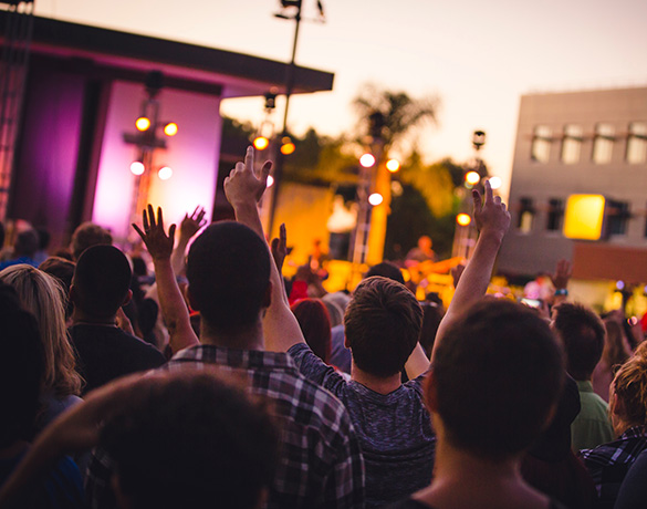 Students worship at an evening service in front of Calvary Chapel