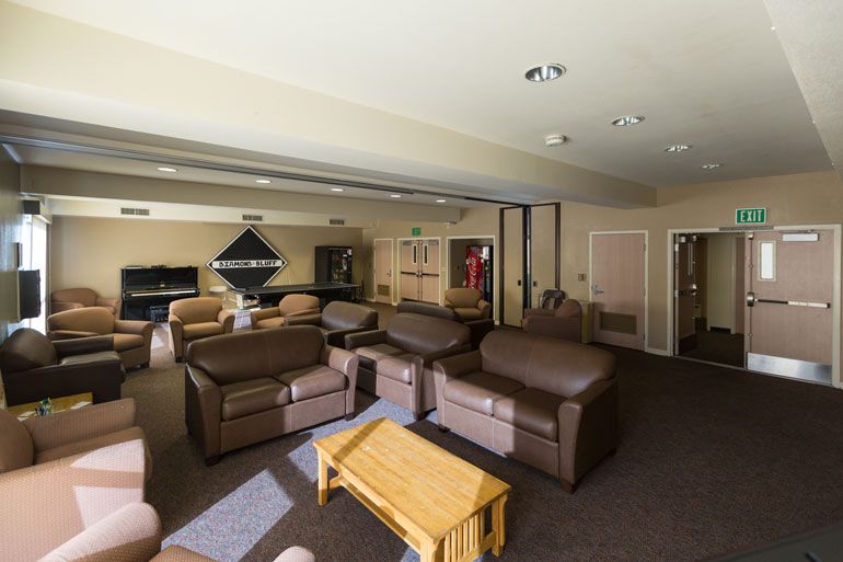 Spacious lobby with couches, pool table, piano and vending machine