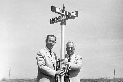 Founders holding biola and rosecrans street sign
