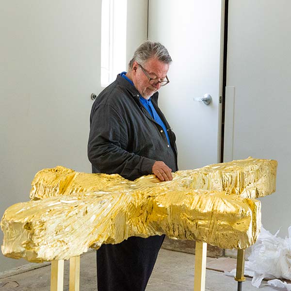 Peter Brandes touches the cross sculpture