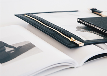 Black notebook and portfolio folder