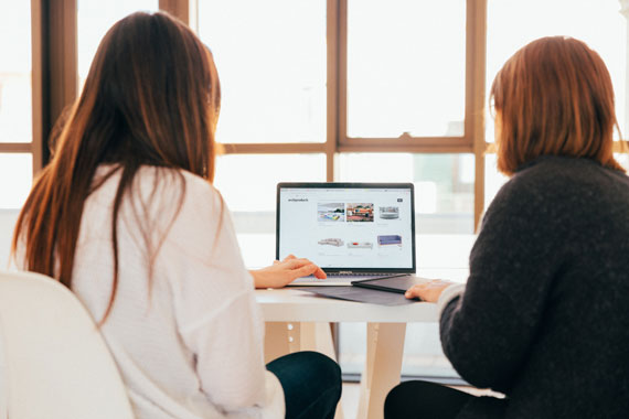 Two people looking at a computer screen