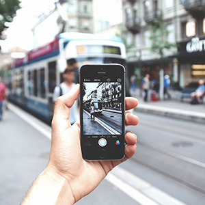 A cell phone taking a photo of a trolley.