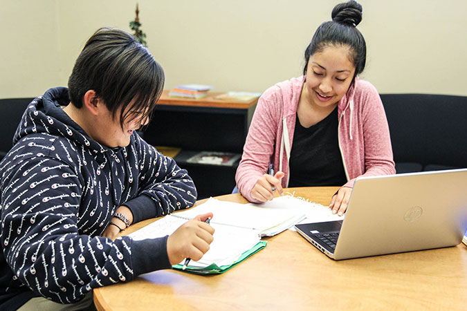 Female student tutoring a younger student
