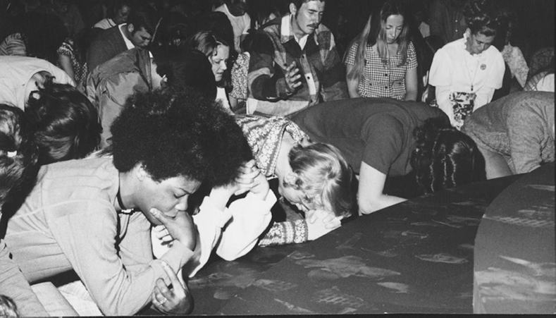 Group worshipping on floor