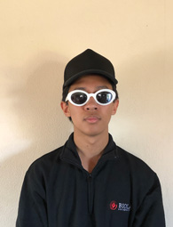 student wearing sunglasses and a hat