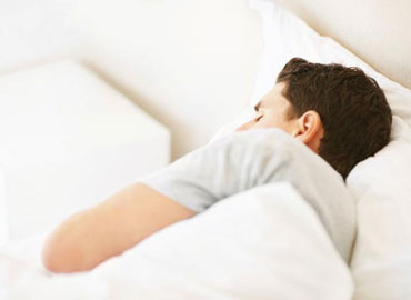 A male subject sleeping in bed