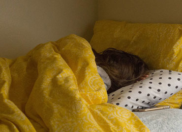 A female sleeping in bed