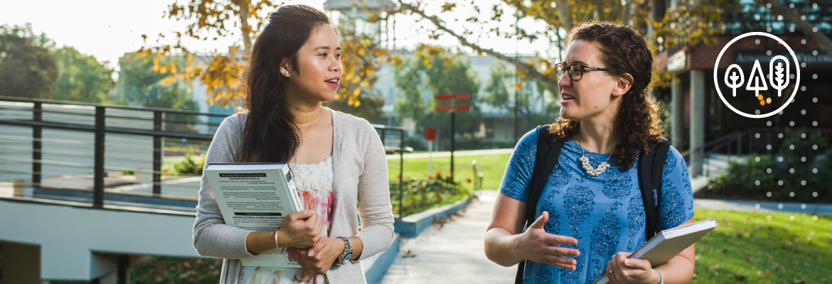 Two female students walking and talking