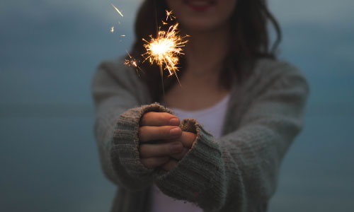 woman holding a sparkler