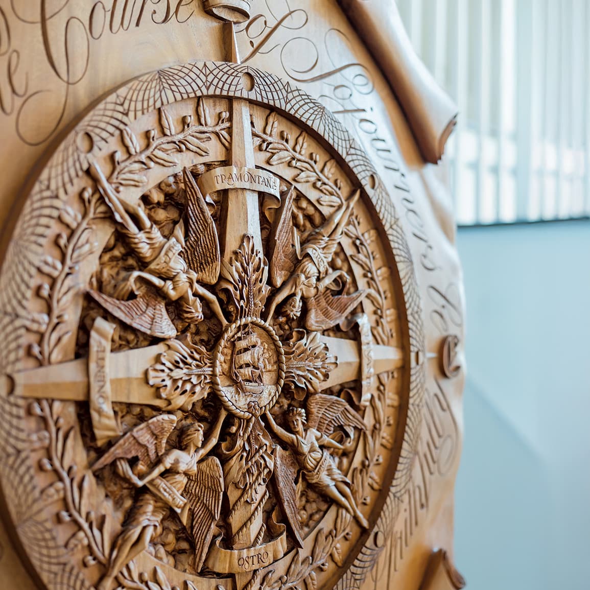 an ornate wood carving of a compass rose