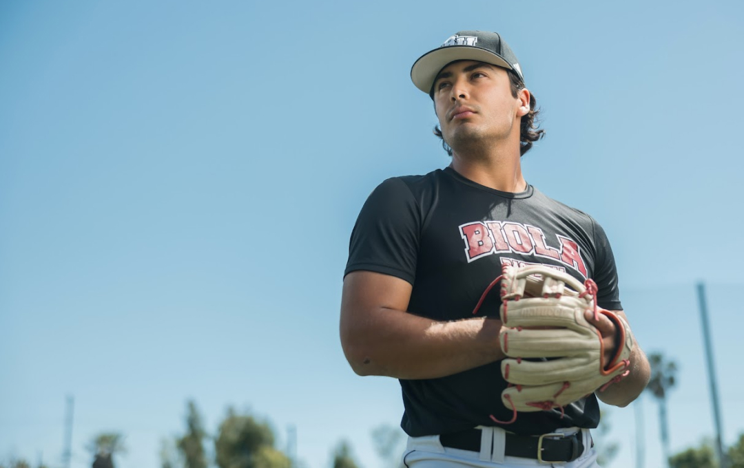 A Biola University baseball player holding a pitching stance.