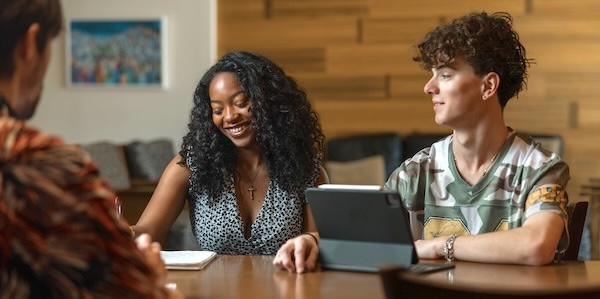 A group of students working at a table together.