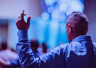 man with arm raised