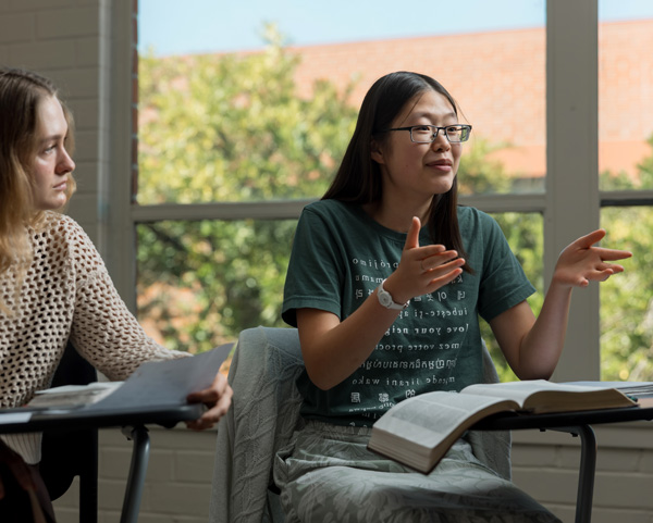 Torrey student in discussion with Bible on table
