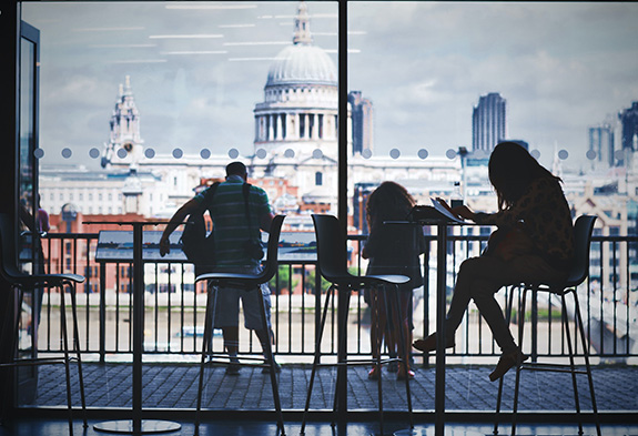 three students sitting in a coffee shop