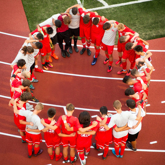 soccer players gathered in a circle