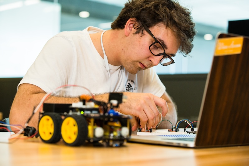 Engineering student working on a robot in class