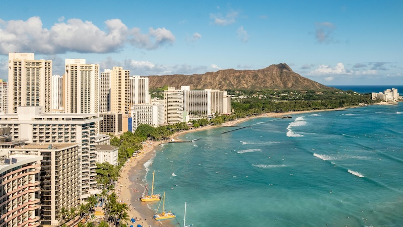 Aerial view of the coast of Hawaii featuring luxury hotels and the beach front.
