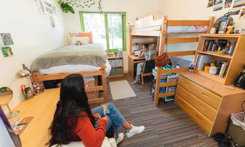 Students sitting in a campus dorm room