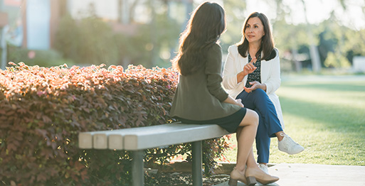 a faculty and student sitting on chairs