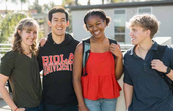 A group of students standing outside smiling