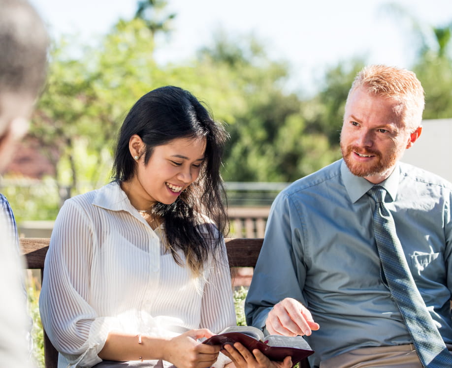 Small group of people discussing a topic with the Bible.