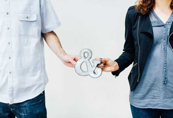 Couple holding an ampersand sign