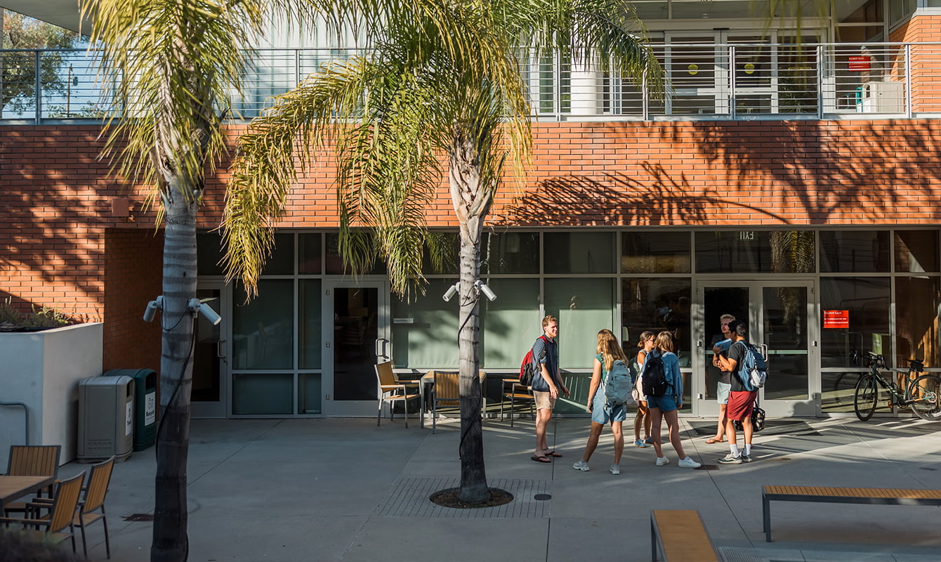 Students stand outside together in a group