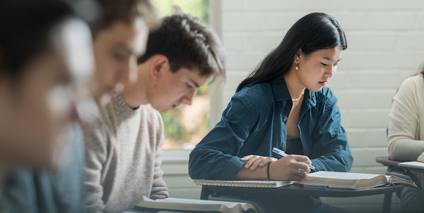 Students sitting at their desks during class working on their studies.