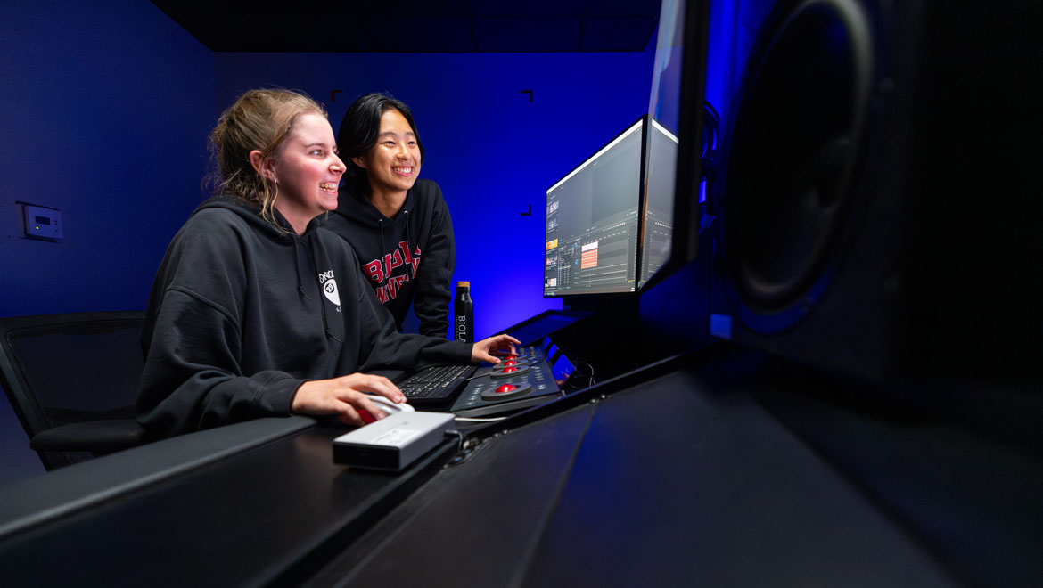 Two students working at an editing bay