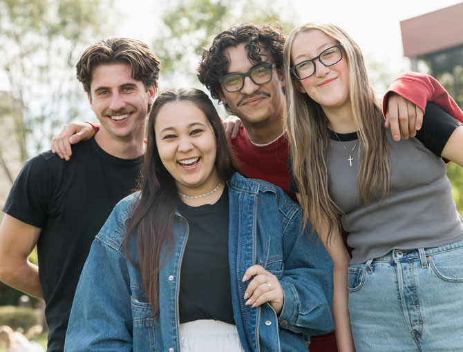 A group of students smiling on Metzger Lawn