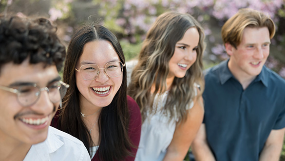 four students smiling