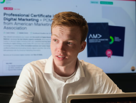 Male student sitting in front of a laptop.