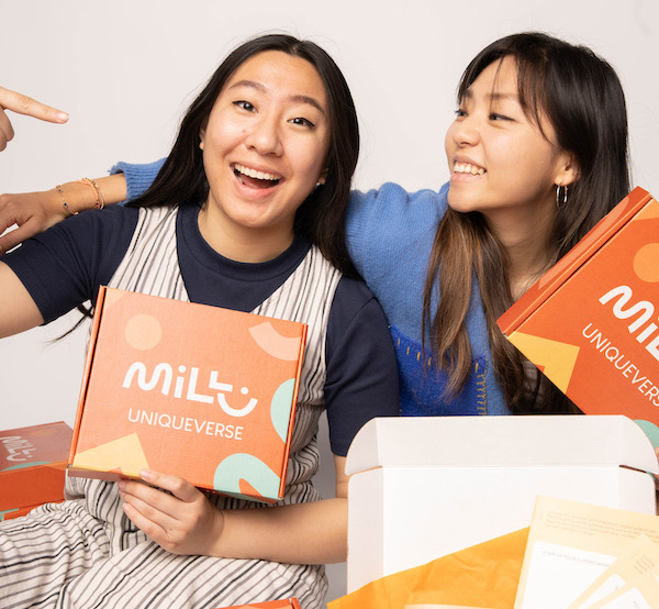 Founders of MILLU holding orange kits