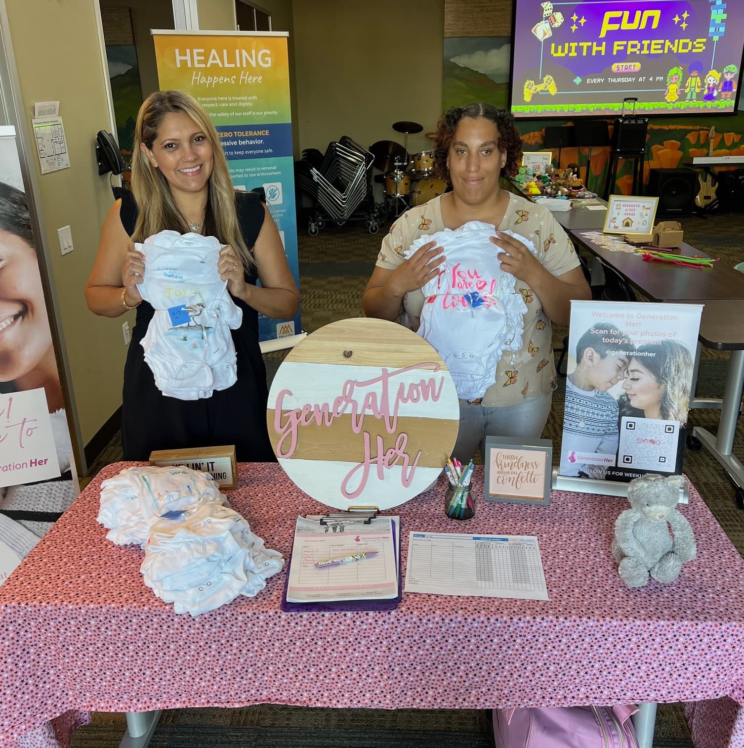 image shows Dianna and another team member with baby items