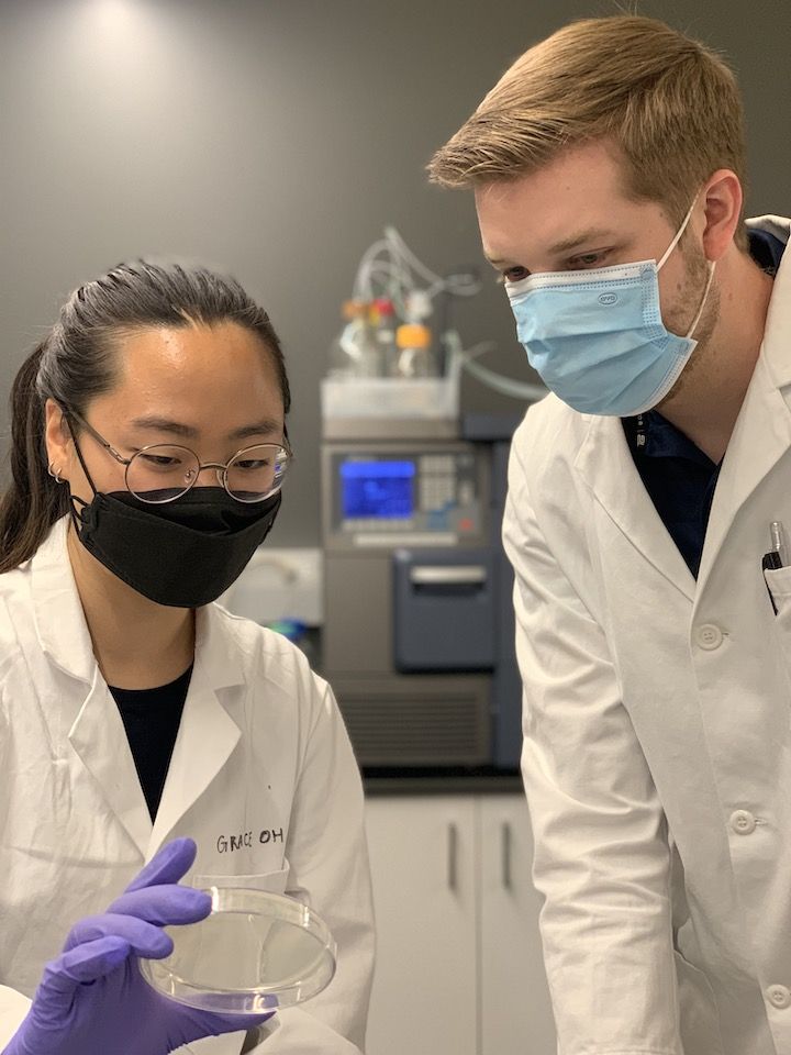 Image shows Grace Oh (left) and Jacob Ulam (right) observing the results for one of our experiments for the nanomachine/virus research.