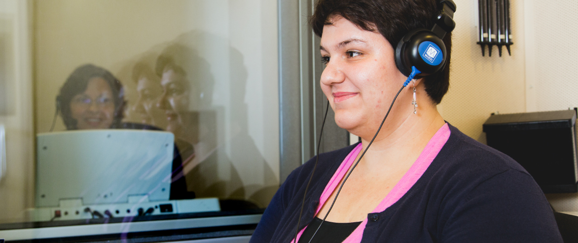 a woman wearing headphones and smiling