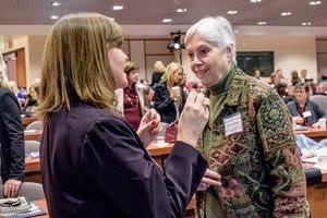 two women talking at an event