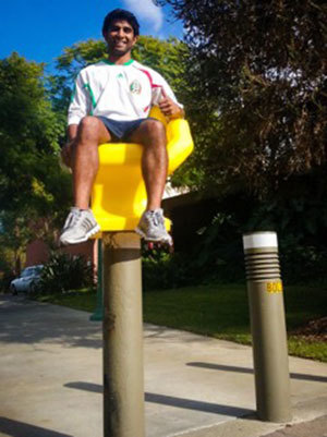 Sam sitting on yellow handshaped chair