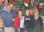 Dave Keehn's family standing in front of Christmas tree