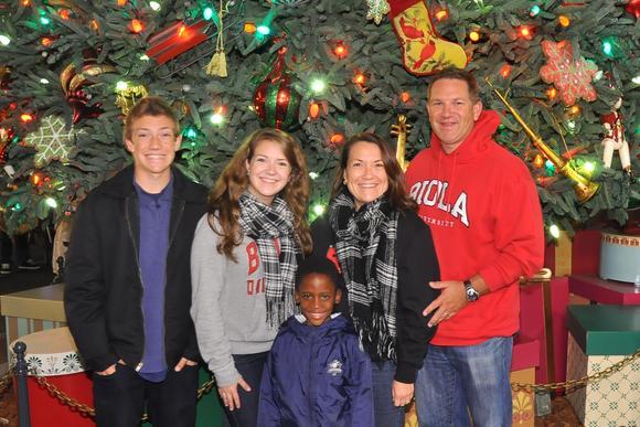 The Keehn family with Mfundo standing in front of a Christmas tree