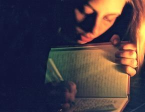 Girl writing in her journal