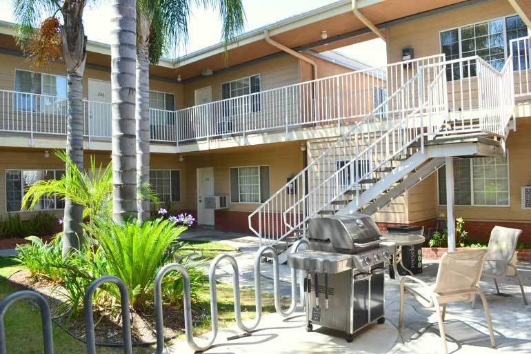 Tradewinds Apartments courtyard with bike rack and barbecue