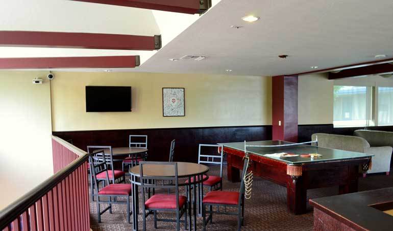Lounge in Stewart Hall including table, chairs, couches and pool table