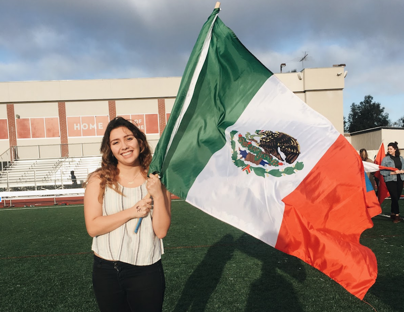 Image is of Melissa Fernanda Valle holding the Mexican Flag