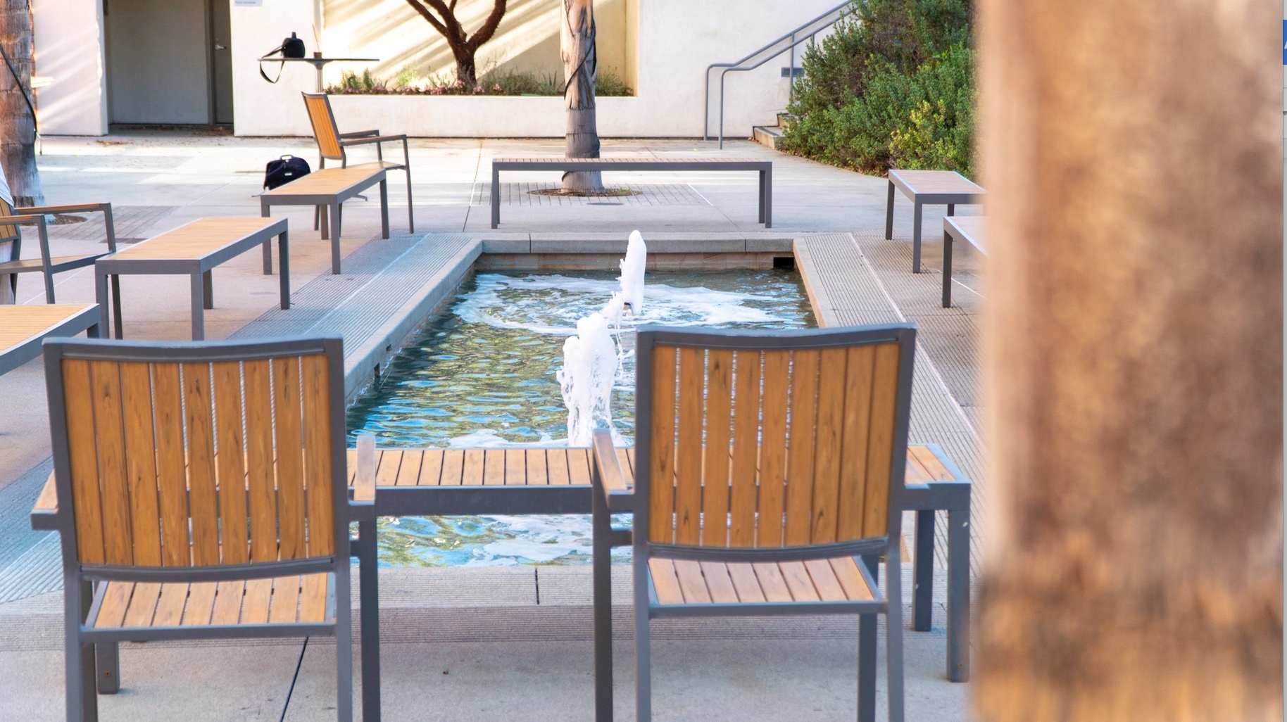 chairs, pool, and fountain outide