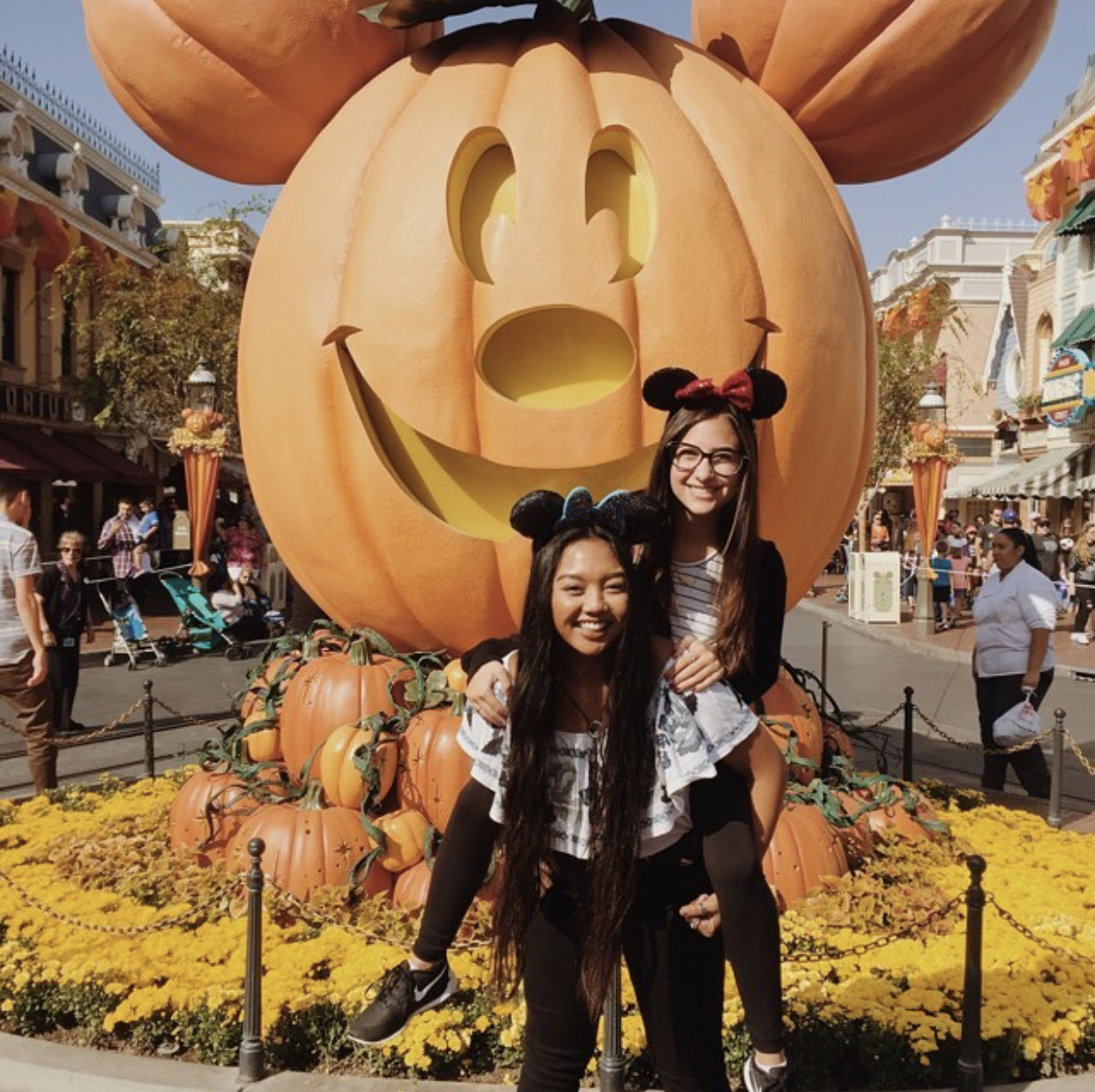 Aubrey and friend in front of Disneyland halloween Mickey Mouse